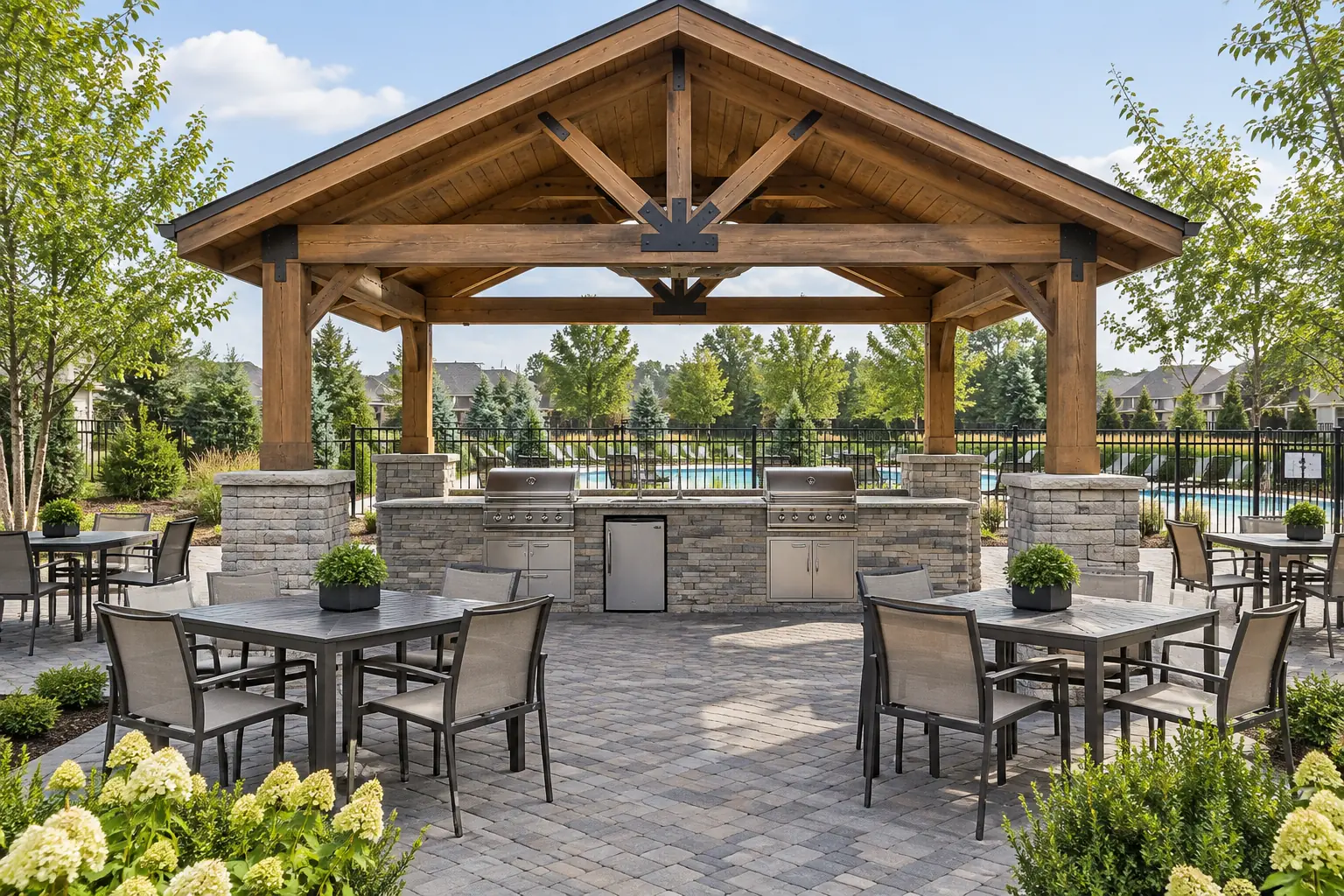 Clubhouse outdoor kitchen with built-in grills under a timber pavilion