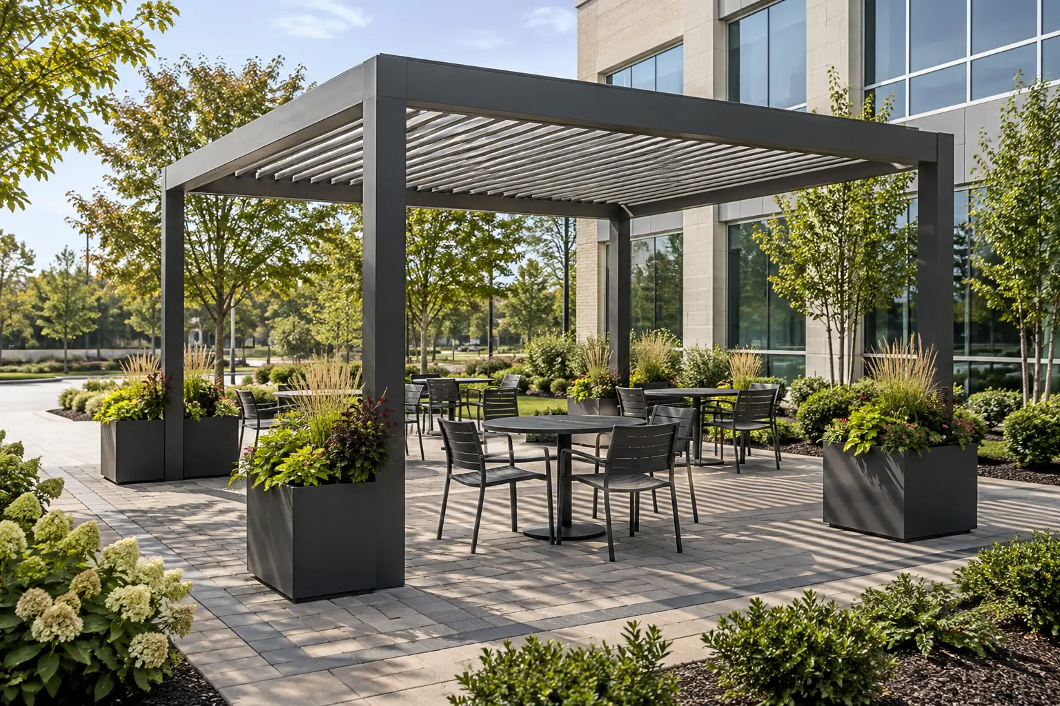 Aluminum pergola over a paver seating plaza outside an office building