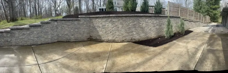 Curved block retaining wall above a driveway in Indianapolis