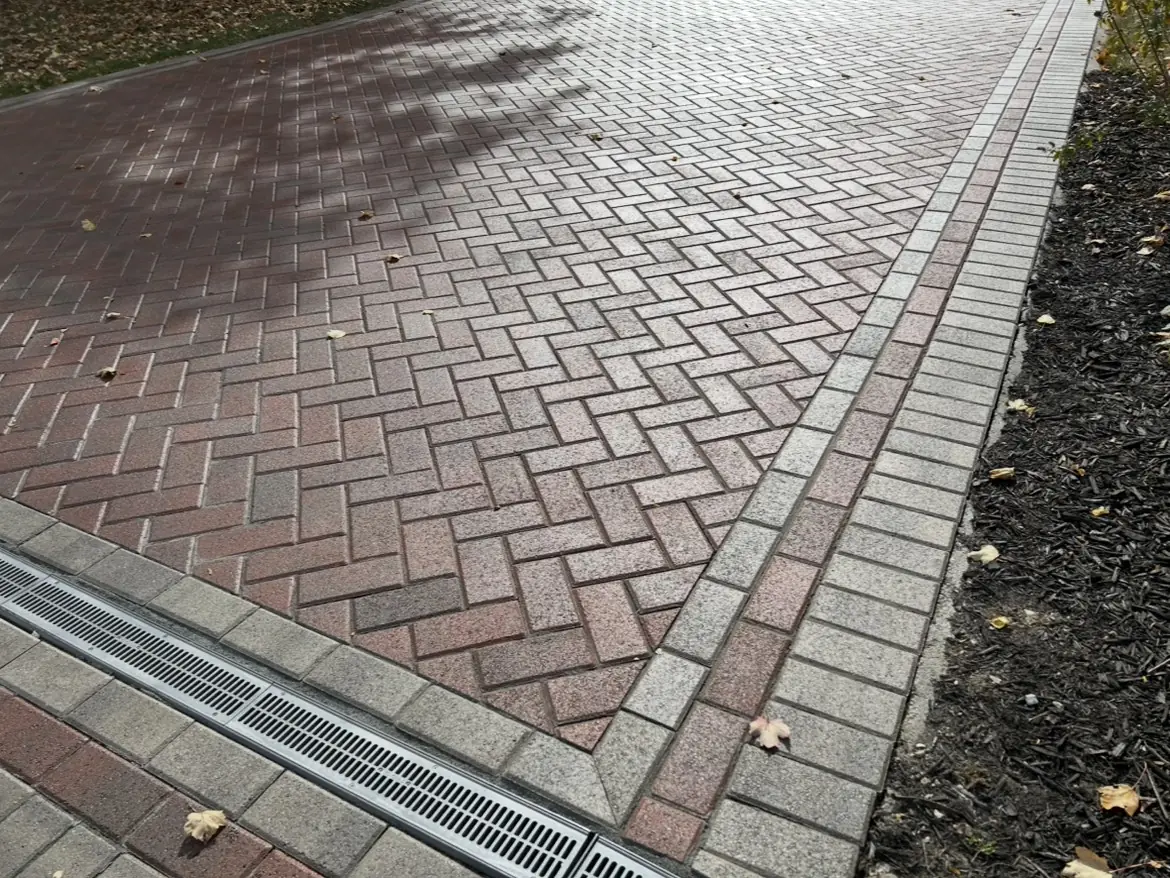 Herringbone pavers with a channel drain set across the surface in Indianapolis