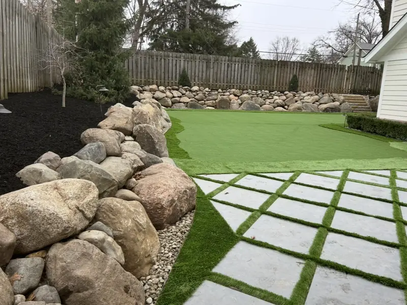 Square pavers with turf joints beside an artificial putting green in Carmel, IN