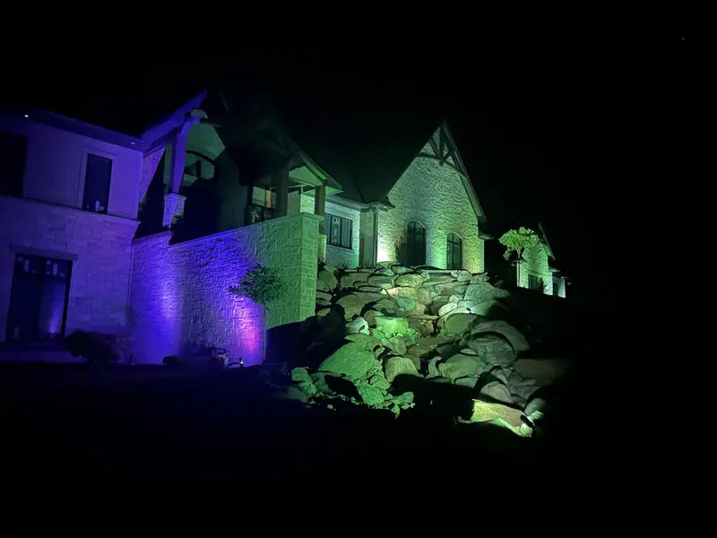 Color-changing landscape lights on a boulder slope at night in Indianapolis