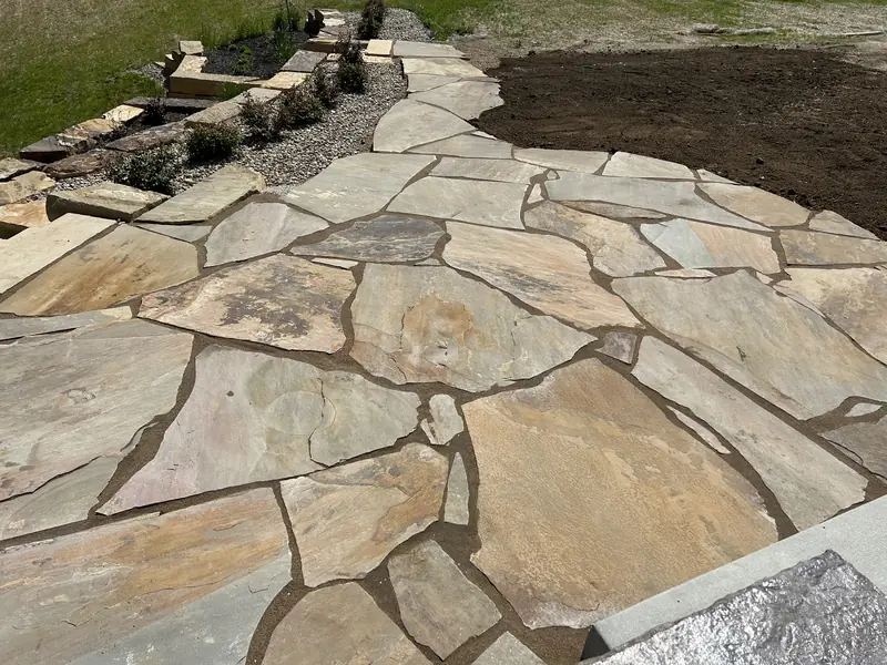 Flagstone patio with natural stone steps behind it in Indianapolis