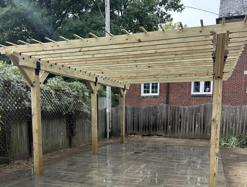 Wood pergola over a large-format paver patio