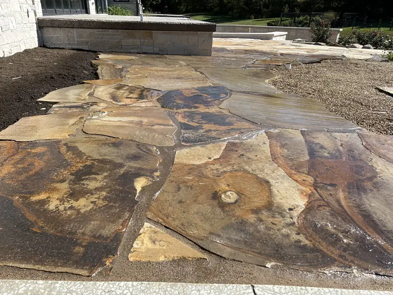 Flagstone patio with a natural stone seat wall in Indianapolis