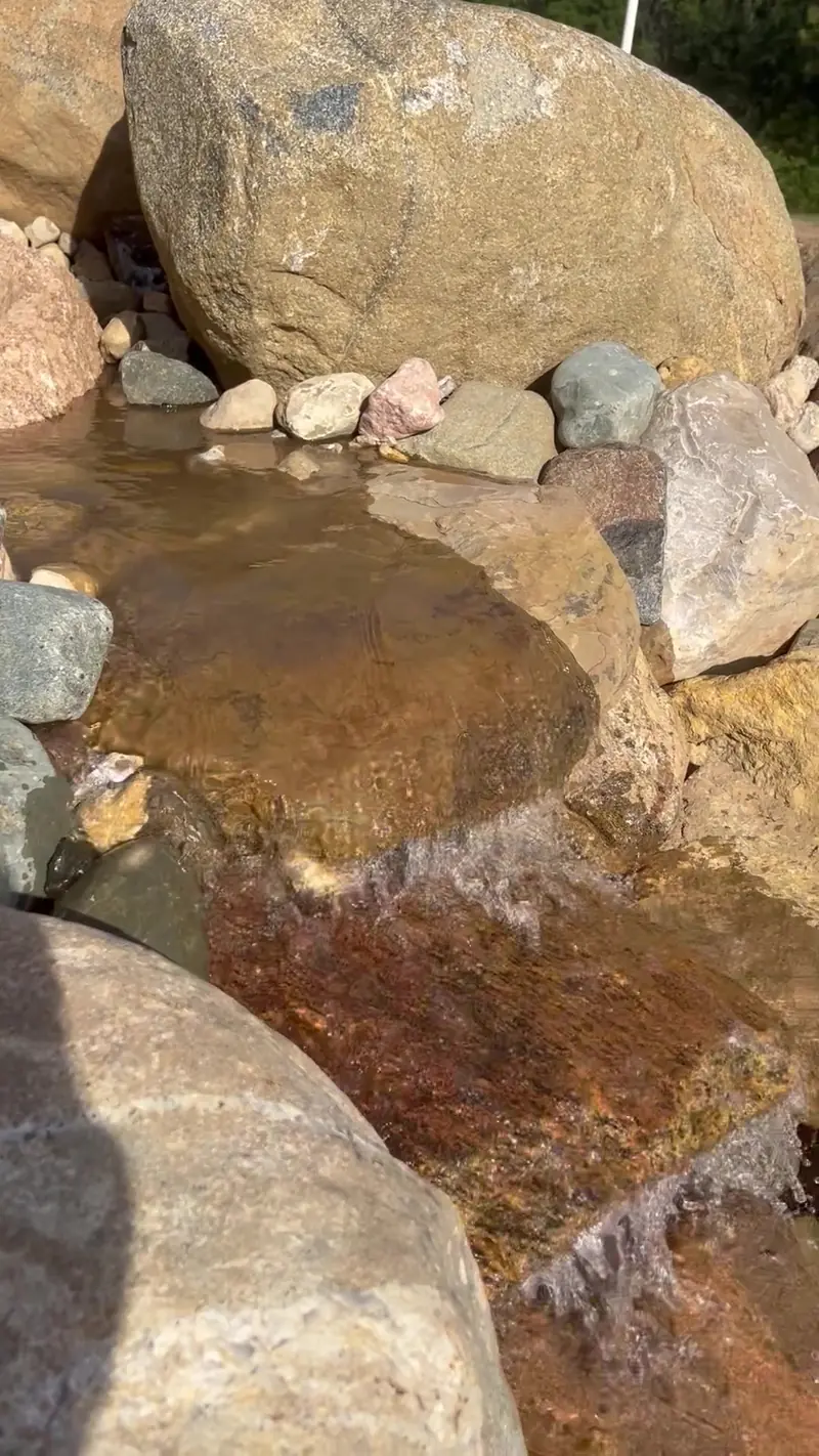 Shallow stream pool between boulders in a pondless waterfall in Indianapolis