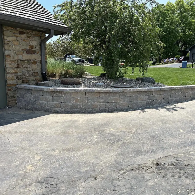 Curved block planter wall around a weeping tree in Indianapolis