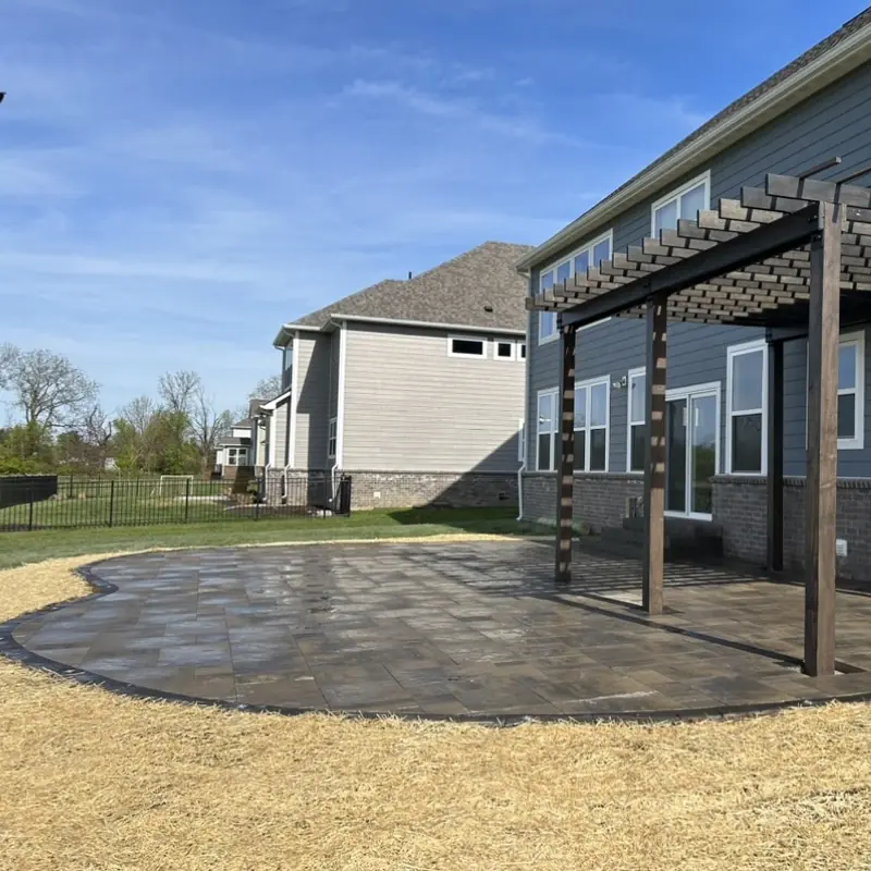 Pergola beside a curved paver patio at a new home in Indianapolis